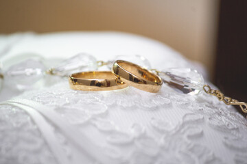 gold rings on the white cushion to be worn at the wedding