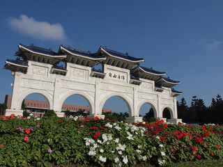 Sunny view of the Liberty Square Arch with many flower blossom