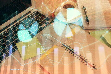 Multi exposure of forex graph drawing and desktop with coffee and items on table background. Concept of financial market trading