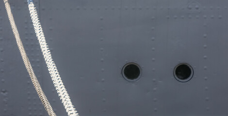 Ship hull and mooring lines.