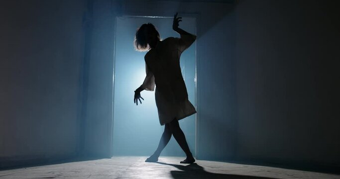 Scary female psychopath crawling in corridor of cursed house with unnatural moves. Exorcist girl awaken by demon - halloween concept 4k footage