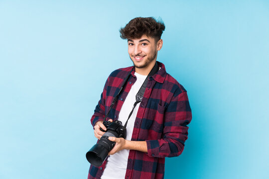 Young arab photographer man isolated laughing and having fun.