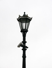 beautiful old vintage street light with surveillance camera