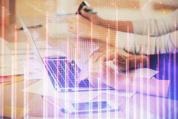 Obraz premium Multi exposure of woman hands typing on computer and financial chart hologram drawing. Stock market analysis concept.