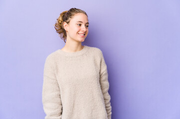 Young caucasian woman on purple background relaxed and happy laughing, neck stretched showing teeth.