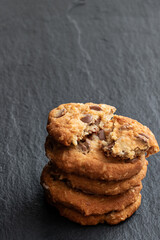 Homemade soft cookies with chocolate drops and coconut on stone bacground