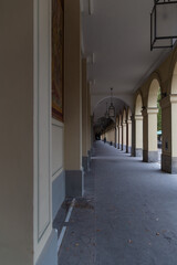 corridor with arches and columns along the wall