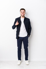 Full body young caucasian man isolated smiling and raising thumb up