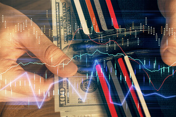 Multi exposure of forex graph drawing hologram and USA dollars bills and man hands. Technical...