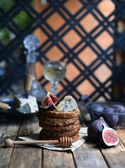 fig with Camembert cheese and honey.   Wine and cheese still life.