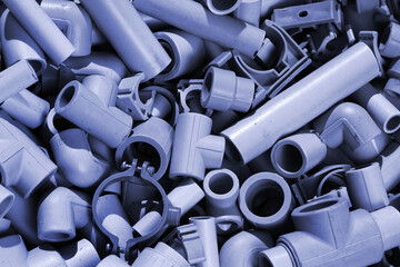 Parts of plastic pipes and fittings as plumbing background