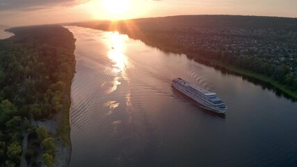 Cruise ship on the river. Cruising ship moves on the Volga river at sunset