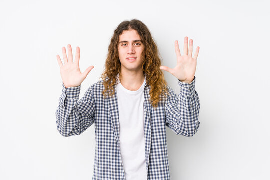 Young long hair man posing isolated showing number ten with hands.
