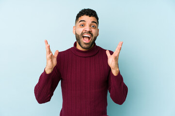 Fototapeta premium Young mixed race arabic man isolated celebrating a victory or success, he is surprised and shocked.
