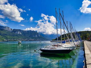 Fototapeta na wymiar Boats docked in the Annecy lake Marina, french alps.
