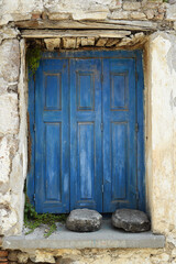 Wooden window of an old abandoned building on the island of Lesvos, Greece.