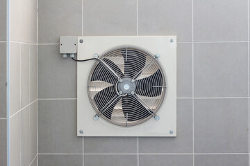 dirty industrial exhaust fan on wall