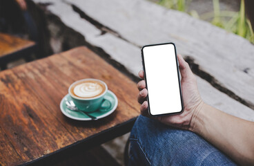 cell phone mockup blank white screen.man hand holding texting using mobile on desk at coffee shop.background empty space for advertise.work people contact marketing business,technology