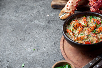 Chilean food. Baked crabmeat crab meat with cheese, cream and bread. Pastel o chupe de sentolla or king crab © lblinova