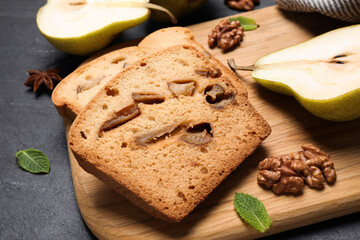 Tasty cut pear bread on black table, closeup. Homemade cake