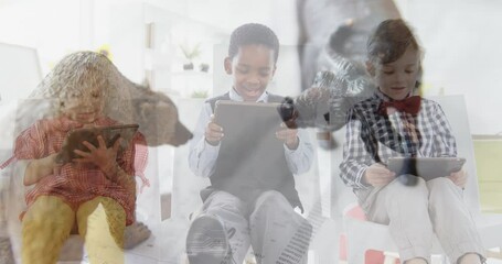 Animals figurines over young people working on tablets. - Powered by Adobe