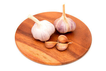 Garlic Cloves and Garlic Bulb on a wooden chopping Board