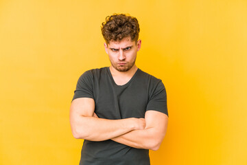  frowning face in displeasure, keeps arms folded.
