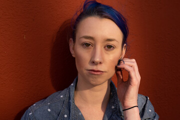 Tall young urban female enjoying the sunshine on a city rooftop overlooking Downtown Los Angeles.