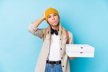 Young caucasian woman holding pizzas isolated being shocked, she has remembered important meeting.