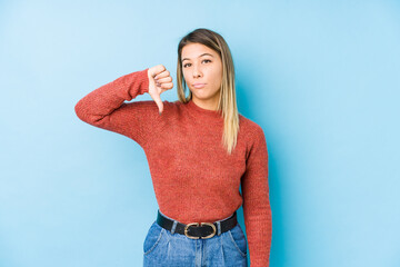 young caucasian woman posing isolated showing a dislike gesture, thumbs down. Disagreement concept.