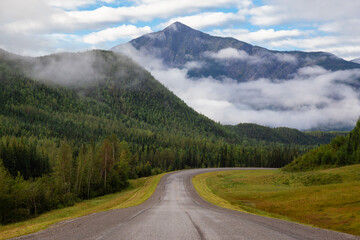 Beautiful View of a scenic road in the Northern Rockies during a sunny and cloudy morning sunrise. Taken in British Columbia, Canada. Nature Background