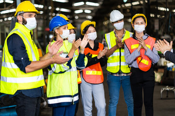 Group of diversity engineers Workers team wear protective face masks for safety in meeting. Success Worker man wearing face mask prevent covid-19 virus and protective hard hat.