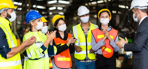 Obraz na płótnie Canvas Group of diversity engineers Workers team wear protective face masks for safety in meeting. Success Worker man wearing face mask prevent covid-19 virus and protective hard hat.
