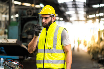 Man at work. Mechanical Engineer  man in Hard Hat Wearing Safety Jacket working in Heavy Industry Manufacturing Facility. Professional Engineer Operating lathe Machinery