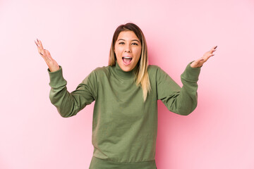 Young caucasian woman posing isolated  receiving a pleasant surprise, excited and raising hands.