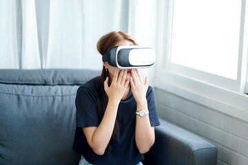 VR BOX GAME Asian woman wearing virtual reality VR headset box immerse interactive playing video game, at home living room relaxing happy care free time lifestyle, electronic futuristic technology