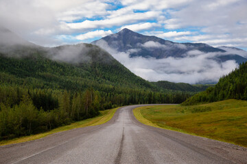 Beautiful View of a scenic road in the Northern Rockies during a sunny and cloudy morning sunrise. Taken in British Columbia, Canada. Nature Background