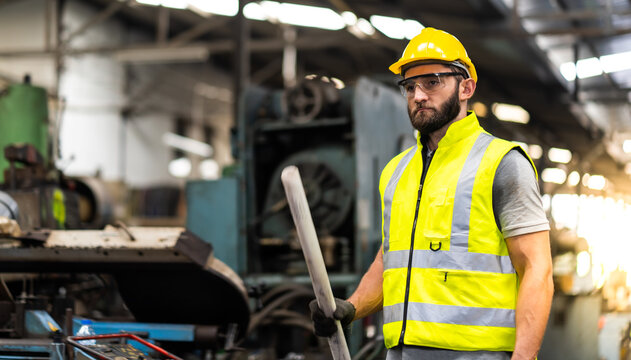Portrait of mechanical worker working on blueprint. Bearded man worker in building helmet or hard hat for safety.