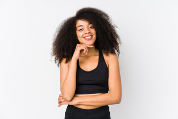 Young african american sporty woman smiling happy and confident, touching chin with hand.