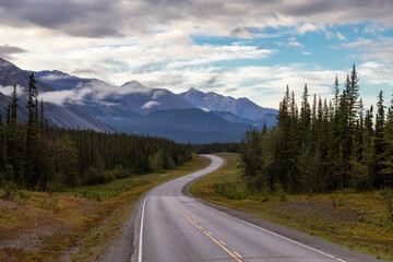 Beautiful View of a scenic road in the Northern Rockies during a sunny and cloudy morning sunrise. Taken in British Columbia, Canada. Nature Background