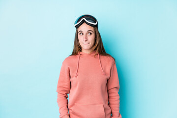 Young skier woman isolated confused, feels doubtful and unsure.