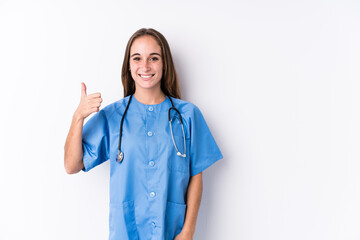 Young nurse woman isolated smiling and raising thumb up
