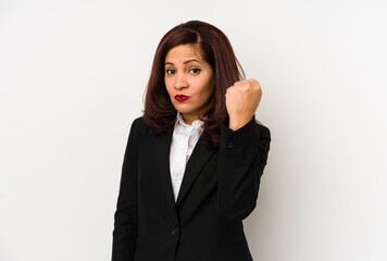 Middle age latin business woman isolated showing fist to camera, aggressive facial expression.