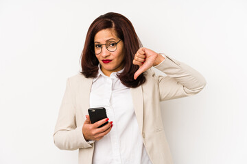 Middle age latin woman holding a mobile phone isolated showing a dislike gesture, thumbs down. Disagreement concept.