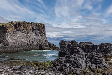 Fototapeta na wymiar The volcanic black basalt landscape at the coast of Hellnar, a small town in Snaefellsnes, Iceland.