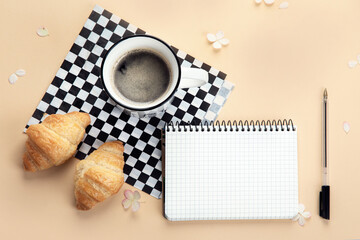 Obraz na płótnie Canvas Notebook with morning coffee and flowers