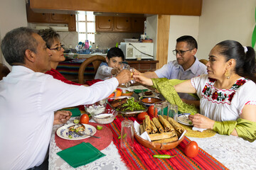 A family toasting to celebrate Independence Day in Mexico