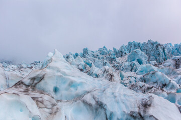 Close view of the blue glaciers in Vatnajokull National Park, in Iceland, on a cloudy day.