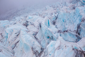 Close view of the blue glaciers in Vatnajokull National Park, in Iceland, on a cloudy day.