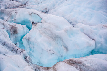 Close view of the blue glaciers in Vatnajokull National Park, in Iceland, on a cloudy day.